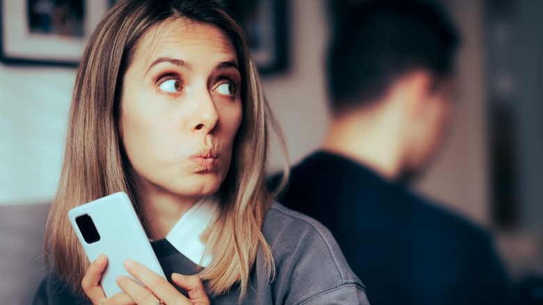secretive woman with cell phone
