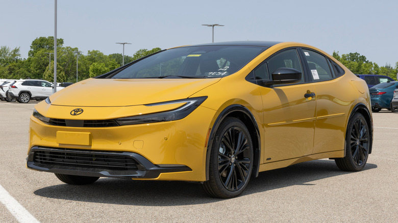 A yellow Toyota Prius Nightshade AWD on display.