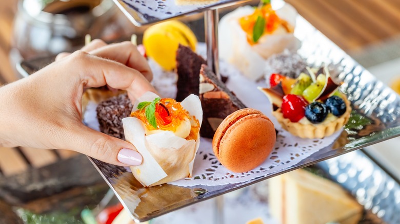 A woman's hand grabbing dessert