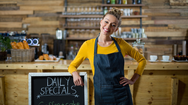 A woman beside a sandwich board
