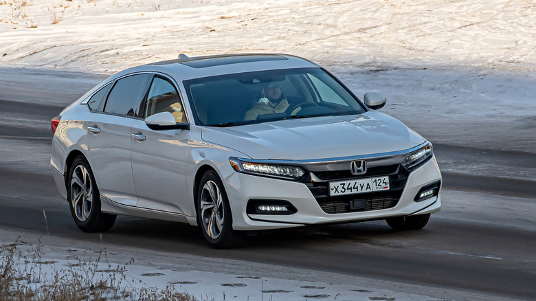 A Honda Accord driving on the road.