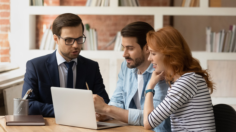 couple speaking with credit advisor