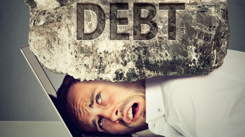 debt, mans head, and laptop