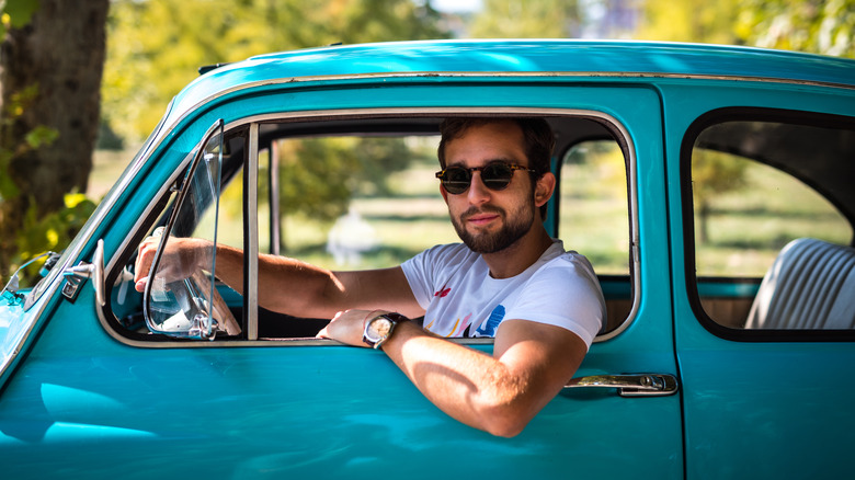 man in older car