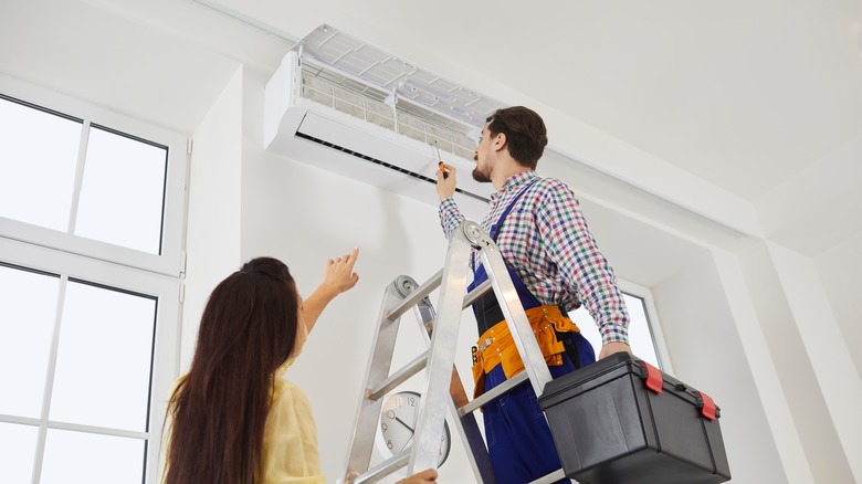 technician repairing AC