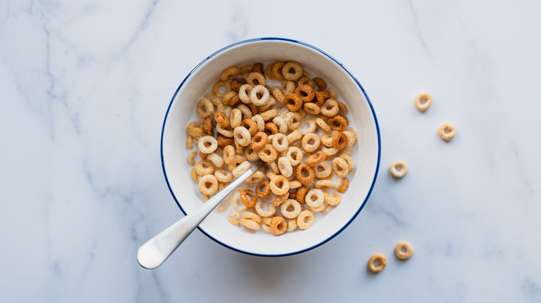 Aerial view of a bowl of Cheerios cereal and milk