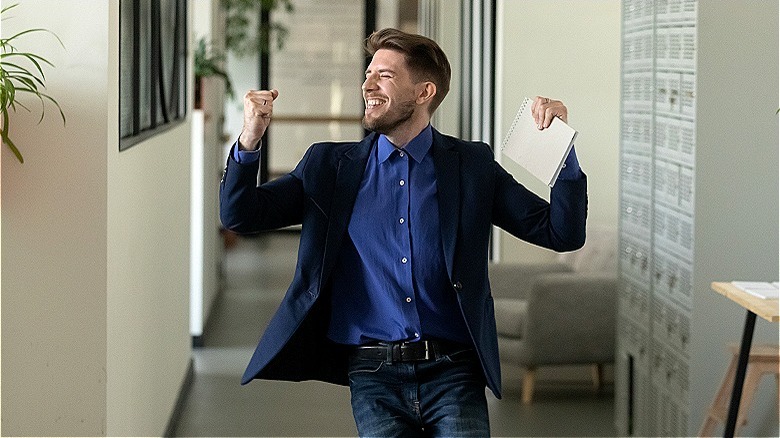 Happy person celebrating at work