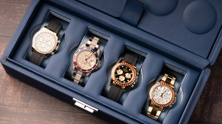 Four different Rolex watches in a blue display case