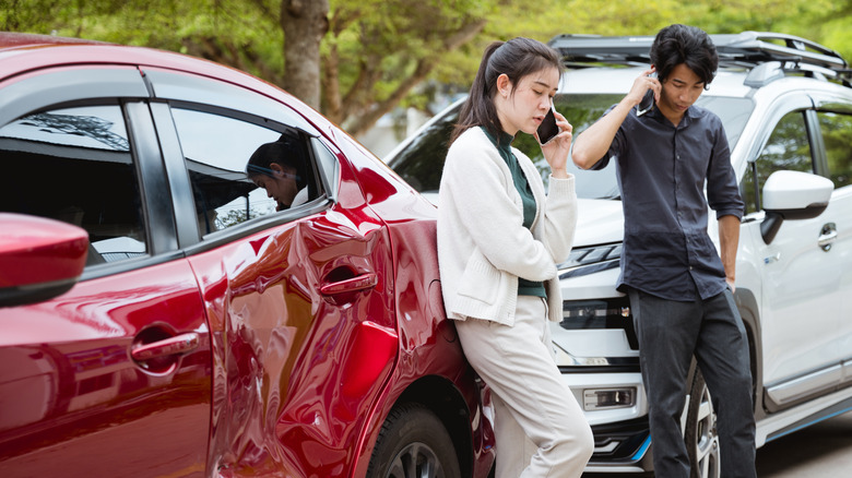 Two drivers outside their cars after an accident