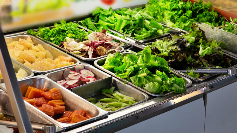 A vibrantly colorful and well-stocked buffet salad bar.