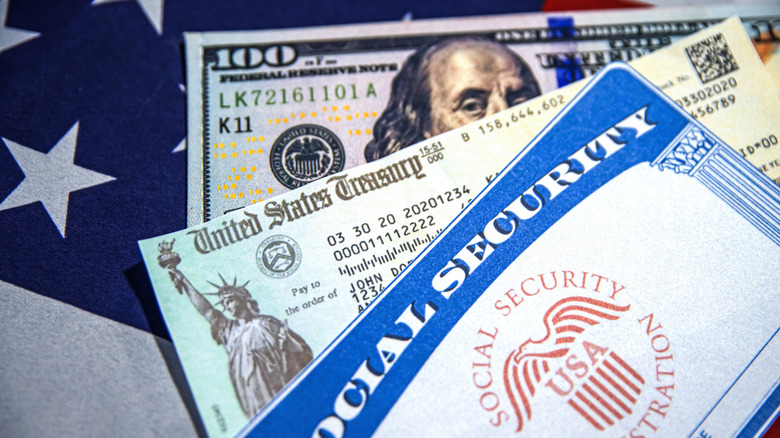 Social Security card, check, $100 bill, and flag