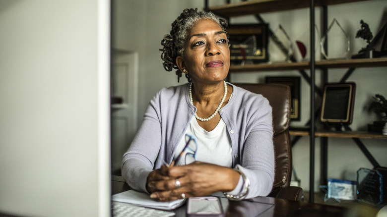 A mature woman sitting at desk