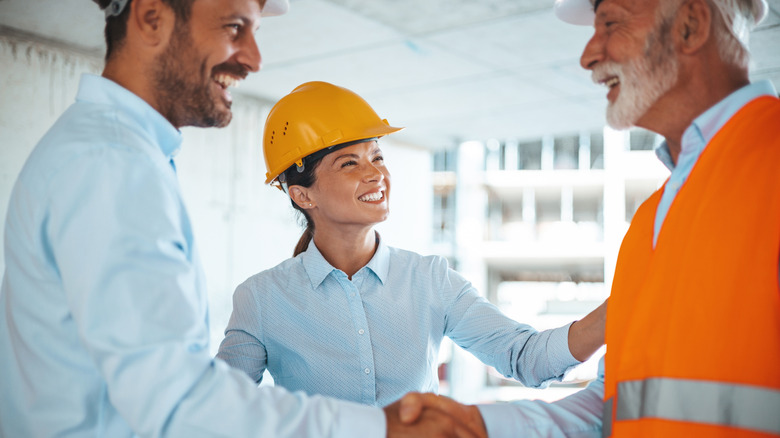 Coworkers  wearing hard hats on jobsite