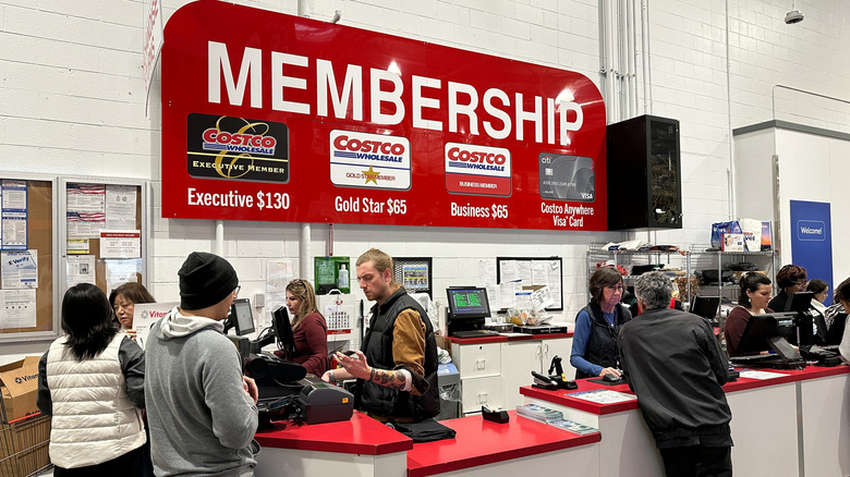 People being waited on at a Costco counter