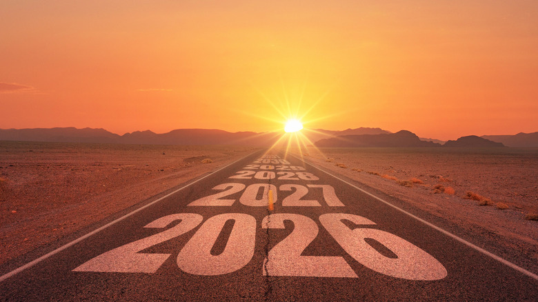 Year numbers on road heading toward horizon