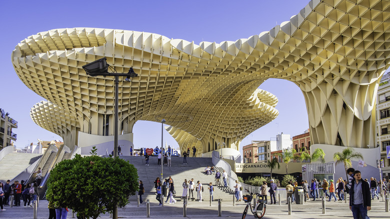The famous architectural structure Setas de Sevilla with people walking around it.