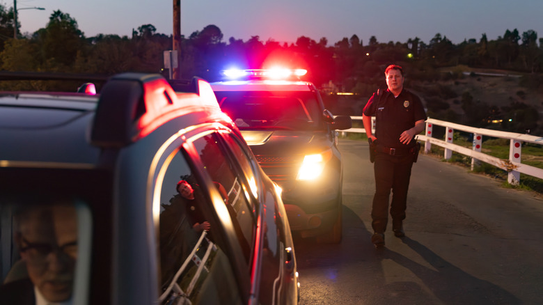 Police officer approaching a stolen car