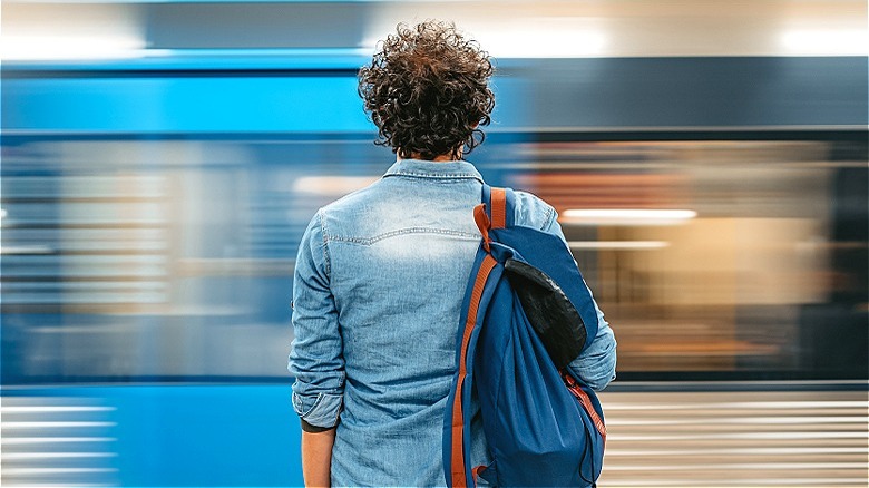 Person waiting, train rushes by