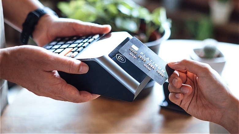 Person preparing to use credit card