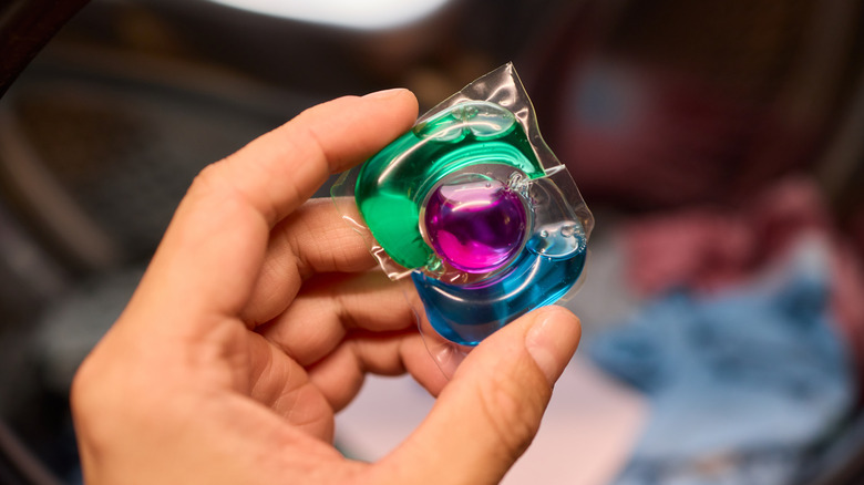 hand holding laundry pod