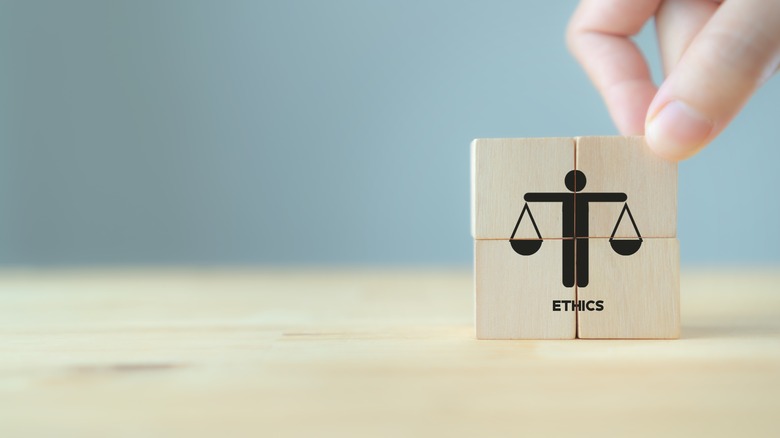 block person holding scales of justice