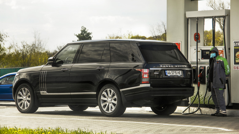 A Range Rover being filled up at gas station