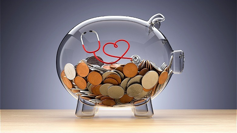 Coins inside transparent piggy bank