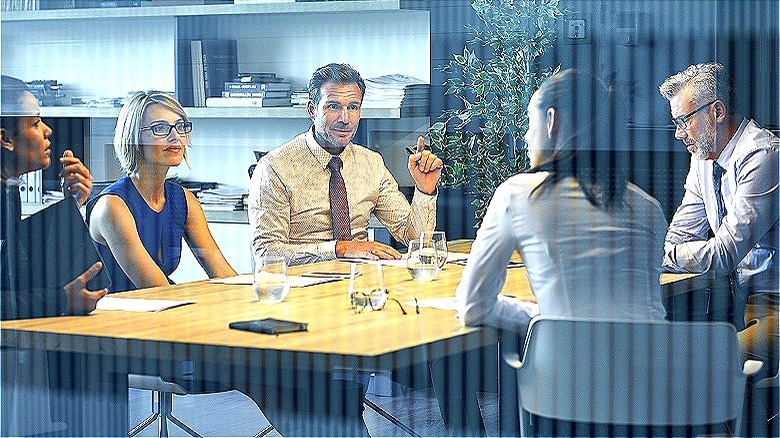 Company meeting behind glass window