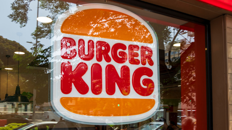 Burger King logo displayed through glass of fast food restaurant