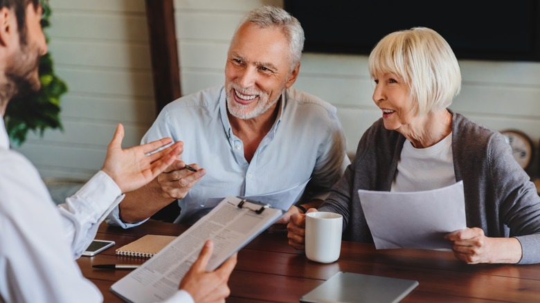 couple speaking to a legal professional about their will