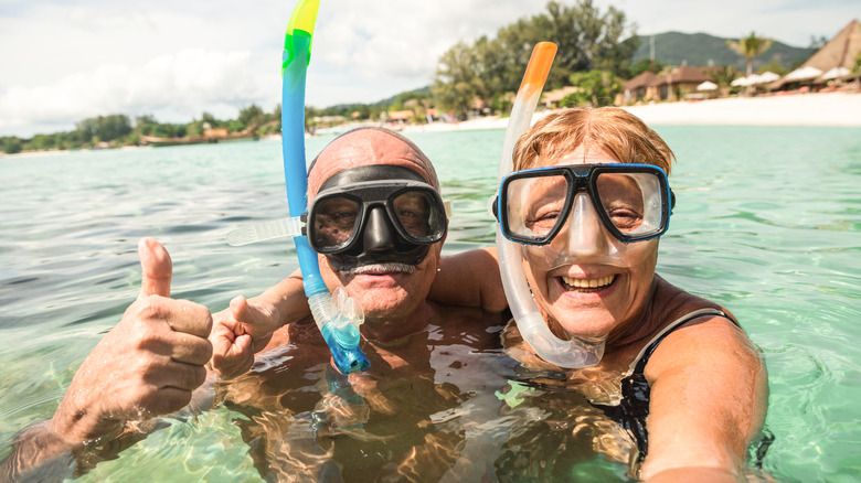 seniors snorkeling on vacation