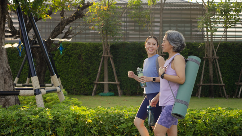 tow people walking in the park