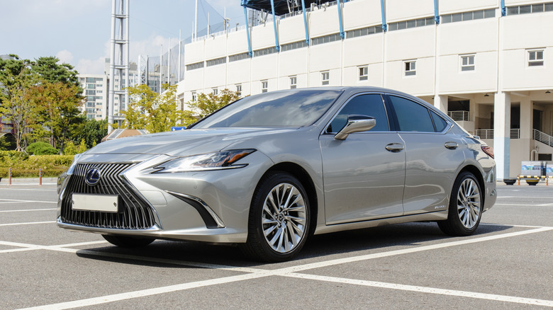 A silver Lexus ES300h hybrid luxury sedan parked in an outdoor parking lot.