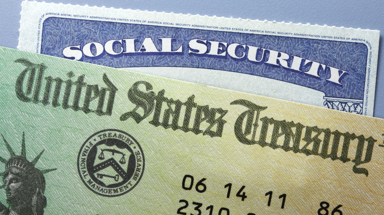 A closeup of a Social Security check and card