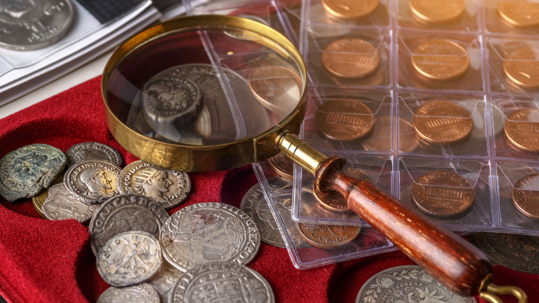 A coin collection with magnifying glass