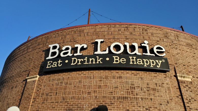 Sign for Bar Louie Restaurant beneath Blue Sky