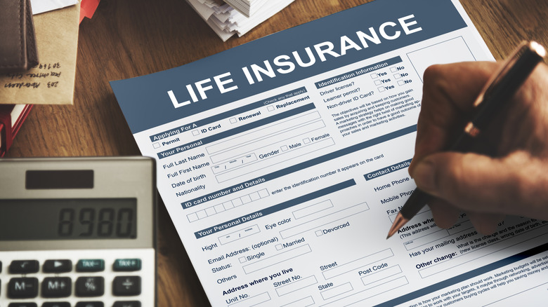 Person filing out life insurance policy