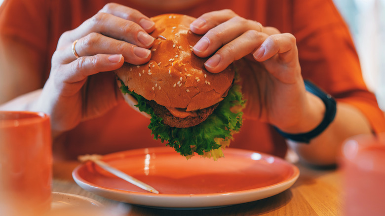 Woman holding healthy burger