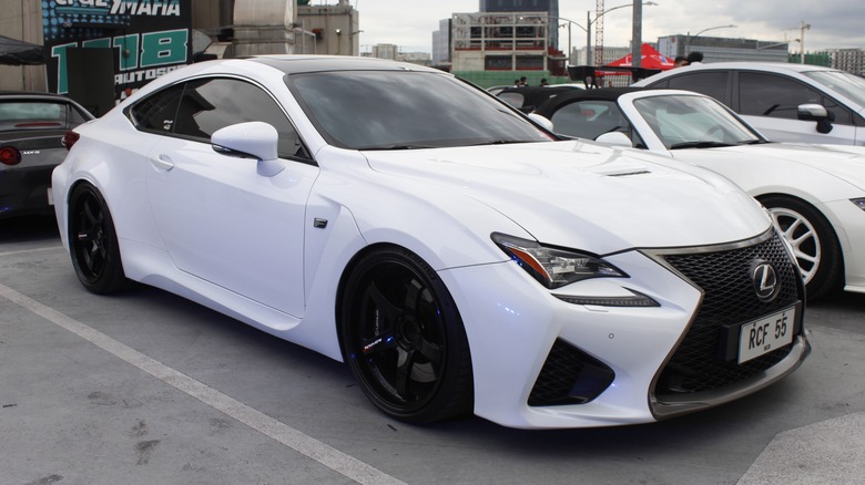 white lexus rcf ini a parking lot