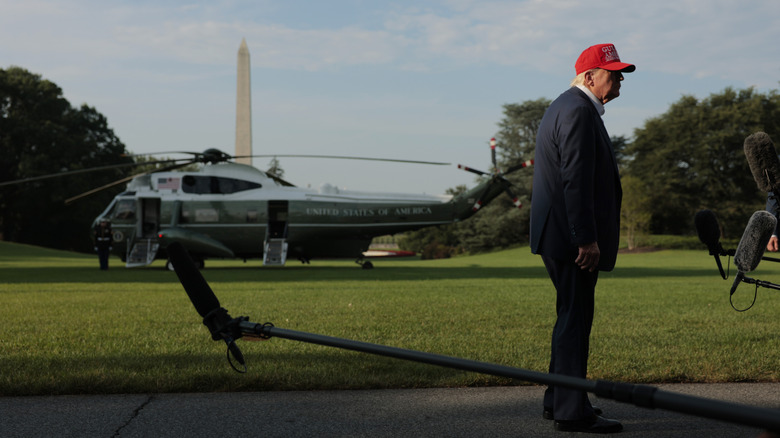 President Trump talks to reports