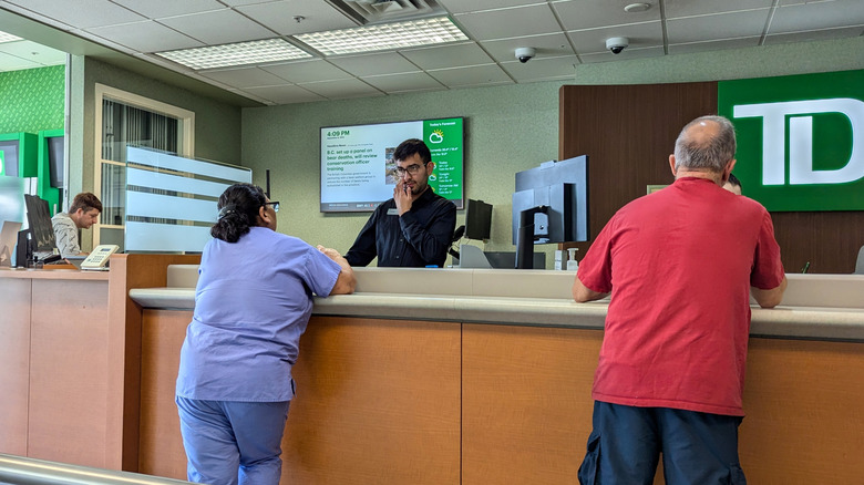 Customers at the counter of a TD Bank branch