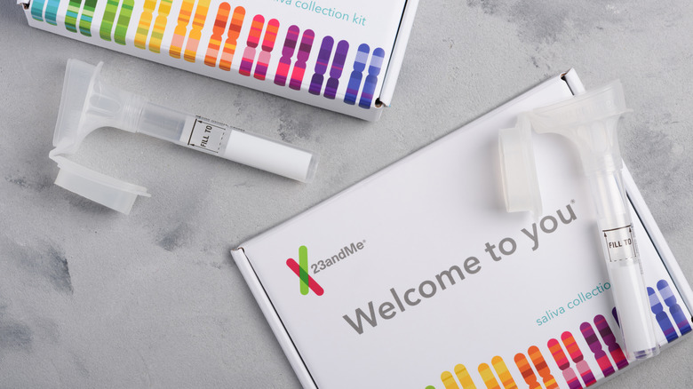 Two rainbow-bright 23andMe test kits on a white marble countertop.
