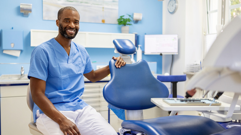 black man with moustache with perfect upper teeth