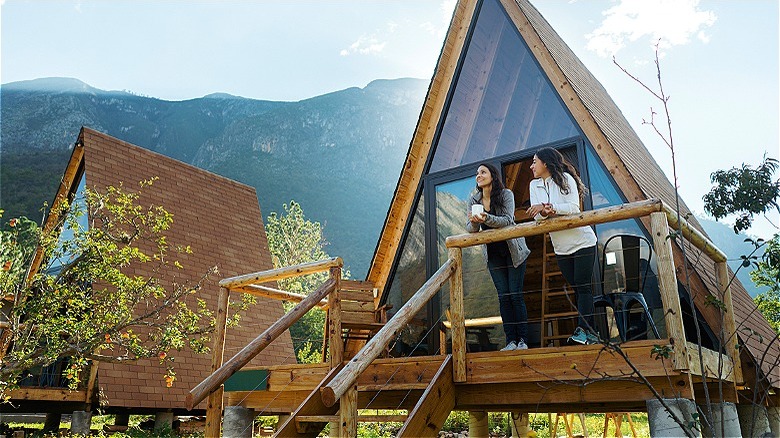 People standing on cabin balcony