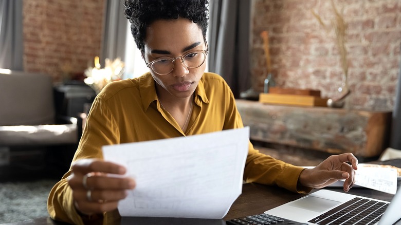 Person at laptop reviewing paper