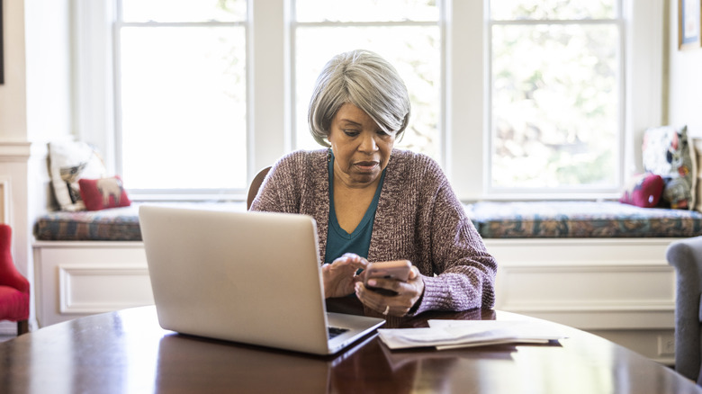 Senior woman paying bills