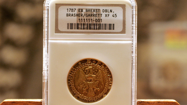 The Brasher Doubloon coin in a case
