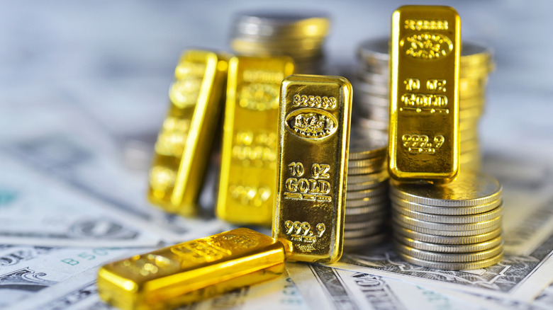 Mini gold bars next to U.S. currency