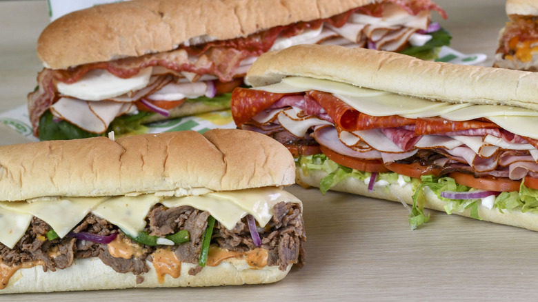 A close-up image of three Subway sandwiches