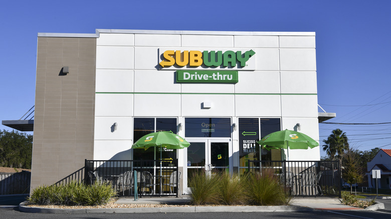 The exterior of a standalone Subway location with a drive-thru